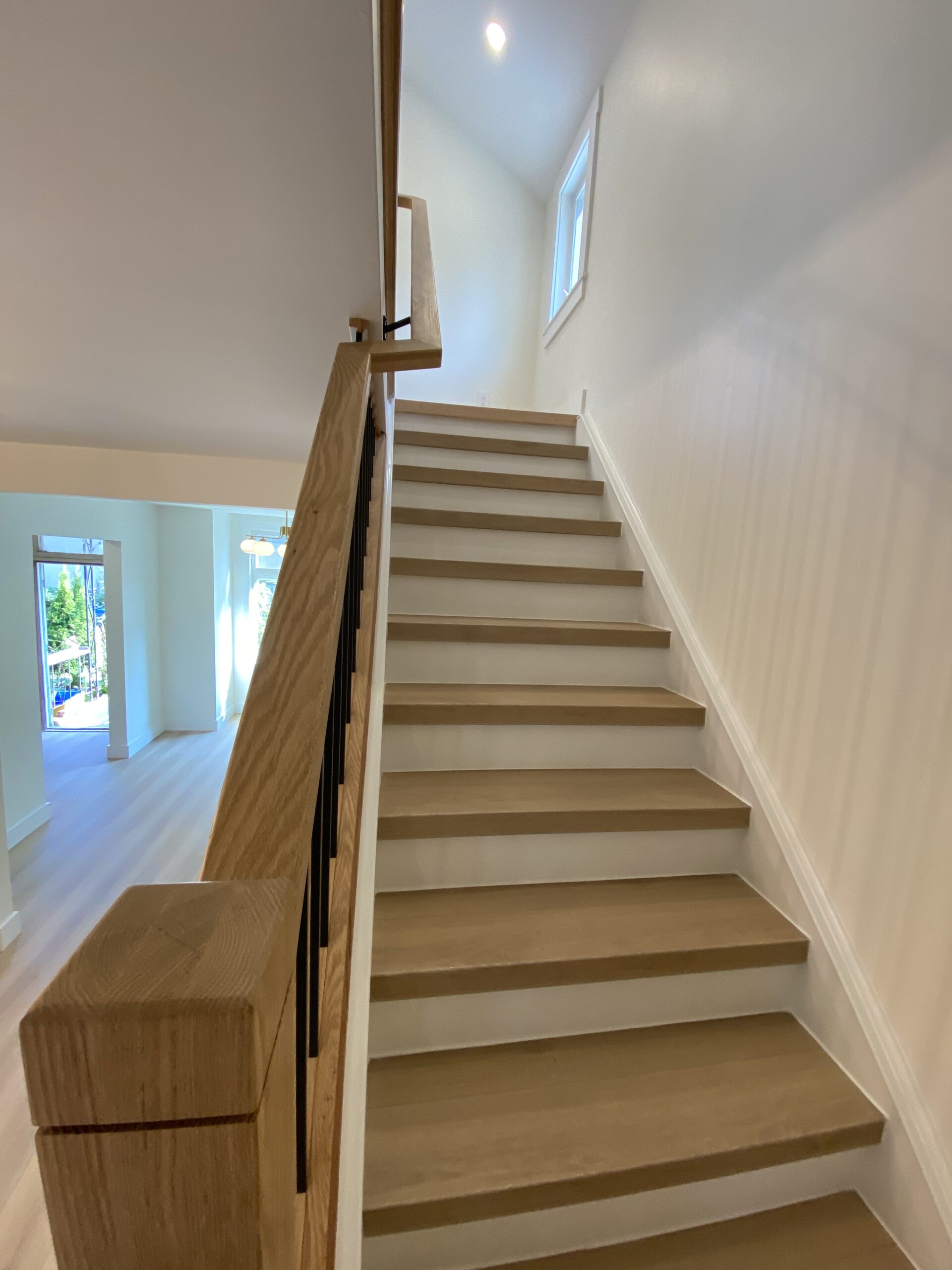Looking up a newly renovated hardwood staircase in Hamilton, Ontario.