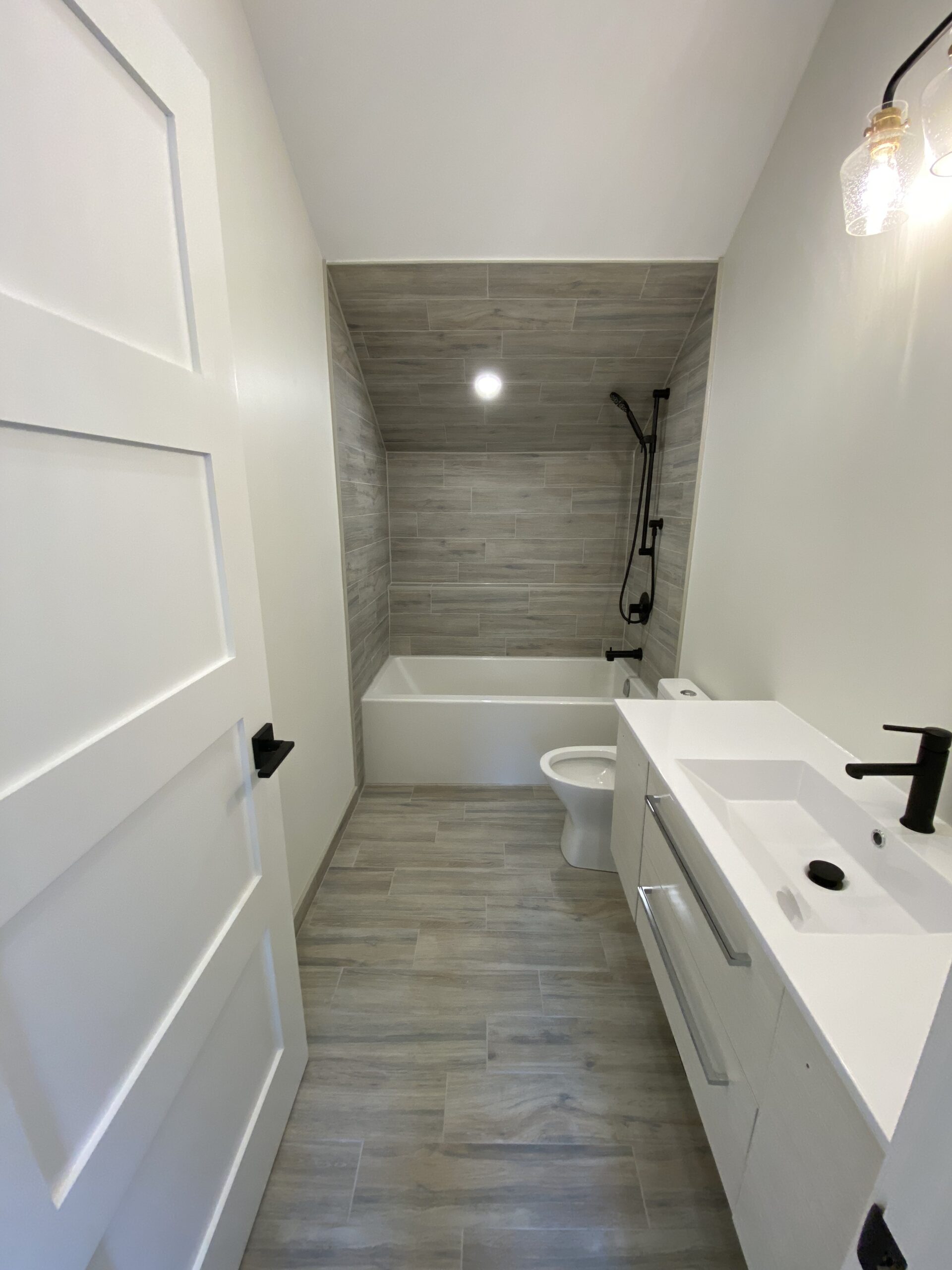 Complete bathroom renovation with new vanity, tub, shower, flooring and other trimmings.