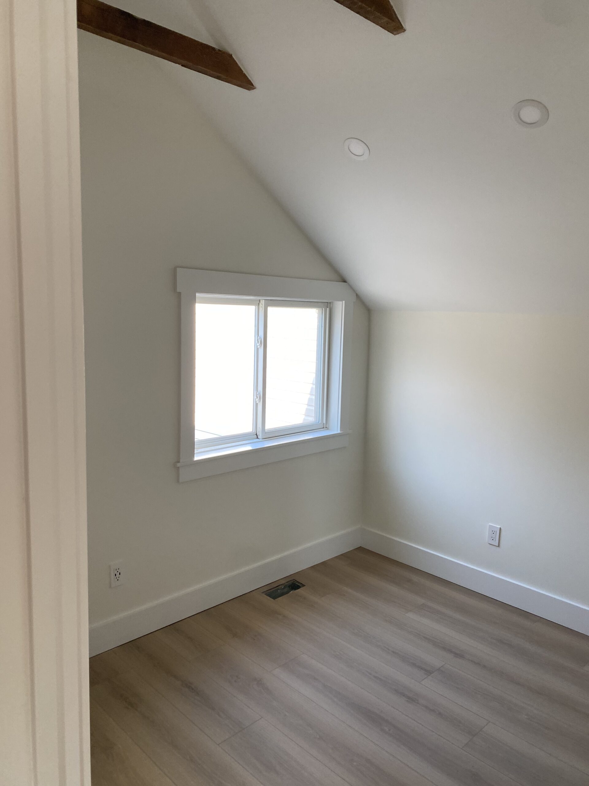 Newly installed wood-style flooring in a guest room.
